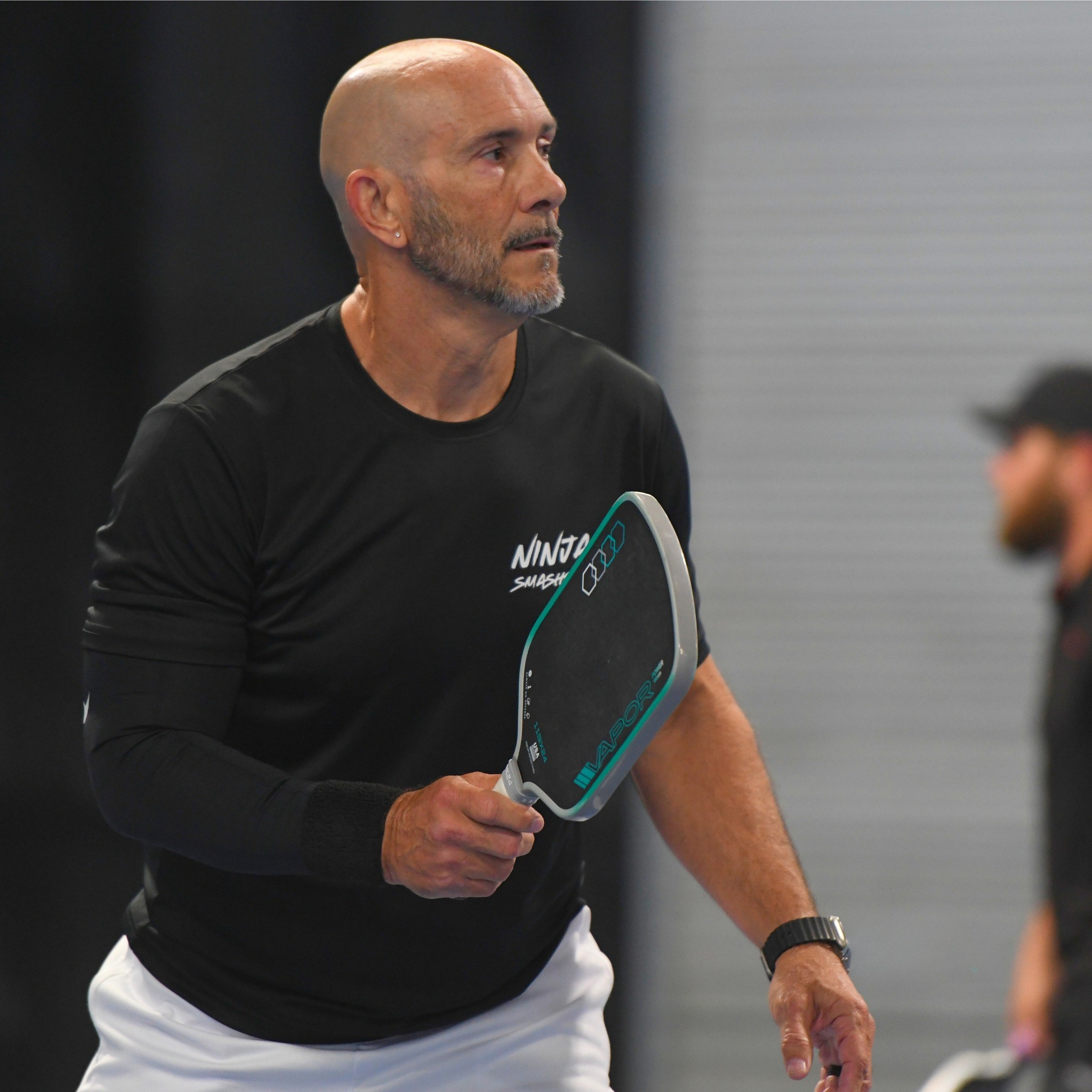 Scott Van Kerkhove on court holding a pickleball paddle